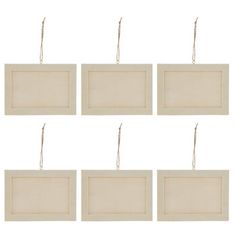 six white wooden frames hanging from strings