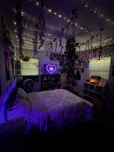 a bed room with a neatly made bed and lots of purple lights hanging from the ceiling