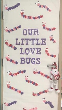 a door decorated with pink and purple hearts that says, our little love bug's