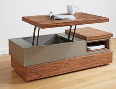 a coffee table with a magazine rack underneath it and a cup on the end shelf