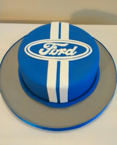 a blue ford cake with white stripes on it's side and the word ford painted on top