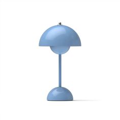 a blue table lamp sitting on top of a white floor