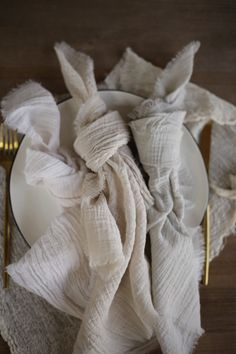 a white plate topped with napkins next to a fork