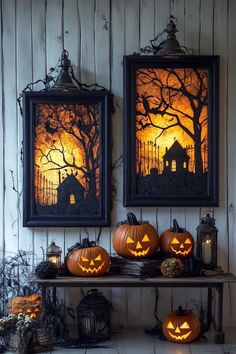 two framed pictures with pumpkins on a shelf