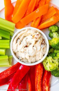 a plate with carrots, celery and broccoli on it