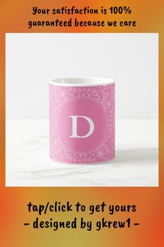 a pink coffee mug with the letter d on it's side and an orange background