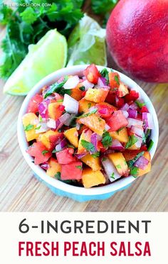 fresh peach salsa in a white bowl with limes and cilantro on the side