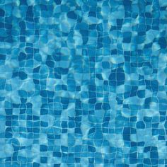 an empty swimming pool with blue tiles on the bottom and water reflecting off it's surface