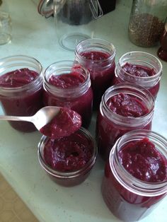 several jars filled with jam sitting on top of a counter