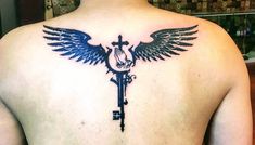 the back of a man's neck with a key and wings tattoo on it