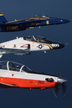 three fighter jets flying side by side in the sky with propellers on their wings, and one is red white and blue