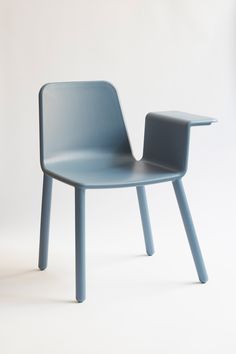 a blue plastic chair sitting on top of a white floor