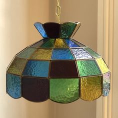 a multicolored stained glass chandelier hanging from a ceiling