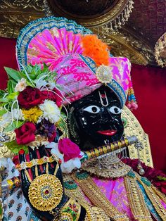 an elaborately decorated mask with flowers on it