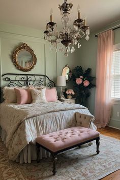 a bed room with a neatly made bed and a chandelier