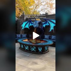 a blue dragon fountain sitting on top of a patio