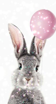 a rabbit holding a pink balloon in its mouth and looking at the camera with glitter on it's ears