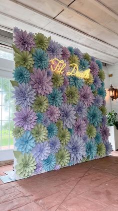 a large flowered wall in the middle of a room with a sign on it