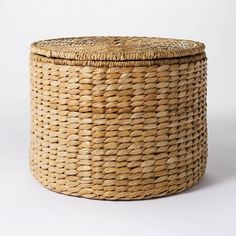 an empty wicker basket is shown on a white background, with the lid open