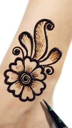 a woman's foot with a henna tattoo on it