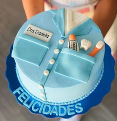 a cake that is shaped like a doctor's coat and medical supplies on it