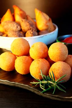 some oranges are sitting on a plate next to other food