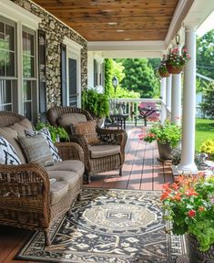 an outdoor porch with wicker furniture and potted plants on the front porch area