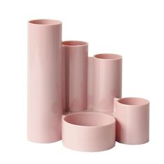 several pink vases are stacked on top of each other