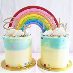 two cakes decorated with rainbows and confetti are sitting next to each other