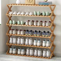 a wooden shoe rack filled with lots of shoes