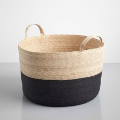 a black and white basket sitting on top of a table