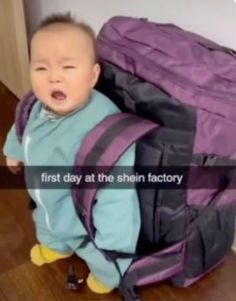 a baby sitting in a purple backpack with the words first day at the shin factory