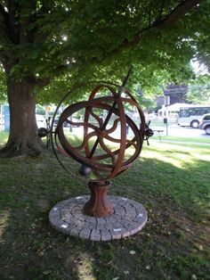 a metal sculpture in the middle of a park