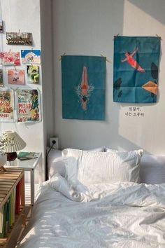 a bedroom with two paintings on the wall