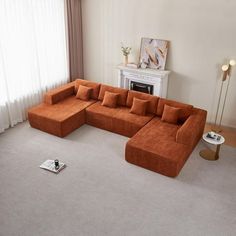 a living room with an orange sectional couch