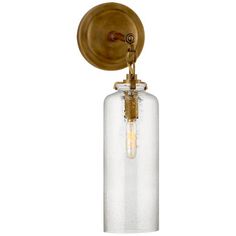 an old fashioned light fixture with a glass cylinder on the side and a brass finish