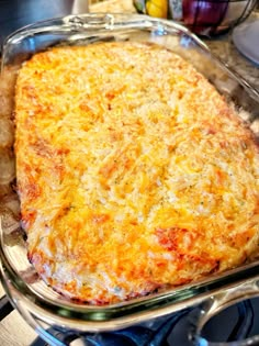 a cheesy casserole in a glass dish on the stove