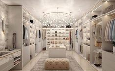 a walk in closet with white walls and shelves