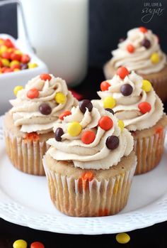 cupcakes with white frosting and candy on top