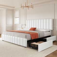 a bed with two drawers underneath it in a white and orange bedroom setting, next to a window