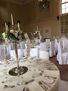 the tables are set with white linens and silverware