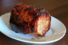 a piece of meat sitting on top of a white plate