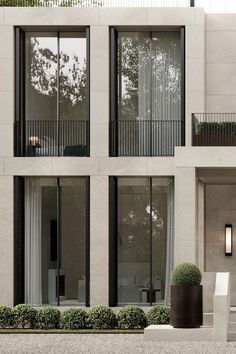 an apartment building with two balconies and windows