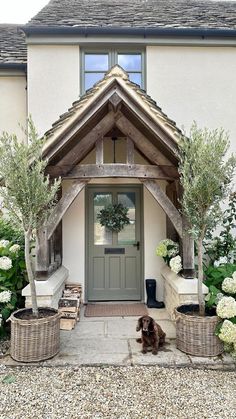 Olive Tree Front Door, Cottage Front Doors Ideas, Front Door Overhang Entrance, Kerb Appeal, Cottage Door, Wicker Planter