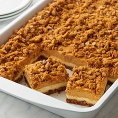 a white dish filled with dessert sitting on top of a table