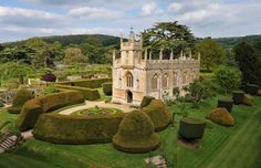 an aerial view of a castle surrounded by hedges