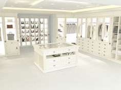 a large white closet with lots of drawers and clothes on display in the middle of it