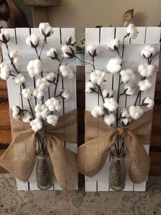 two vases with cotton flowers and burlocks tied to them