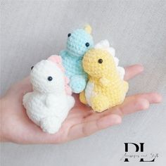 three small crocheted animals are sitting on someone's hand in front of the camera