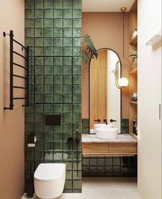 an image of a bathroom with green tiles on the walls